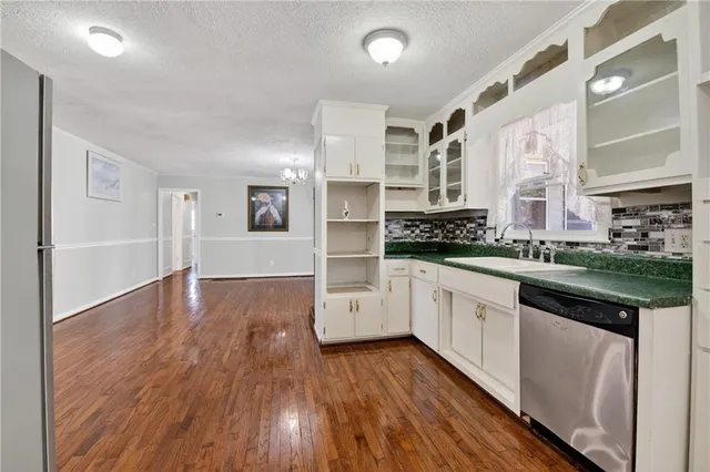 a kitchen with stainless steel appliances a refrigerator sink and cabinets