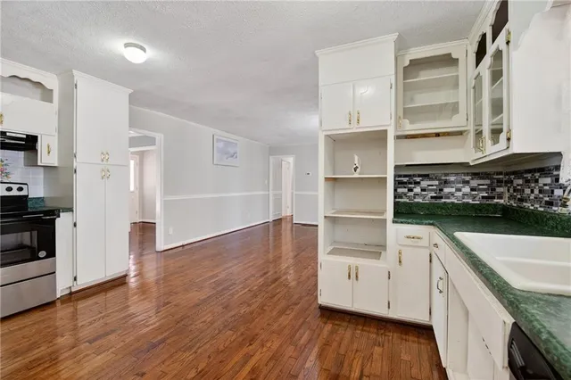 a kitchen with wooden floors and cabinet