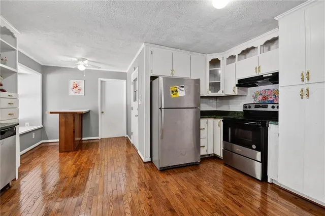 a kitchen with stainless steel appliances a refrigerator sink and microwave