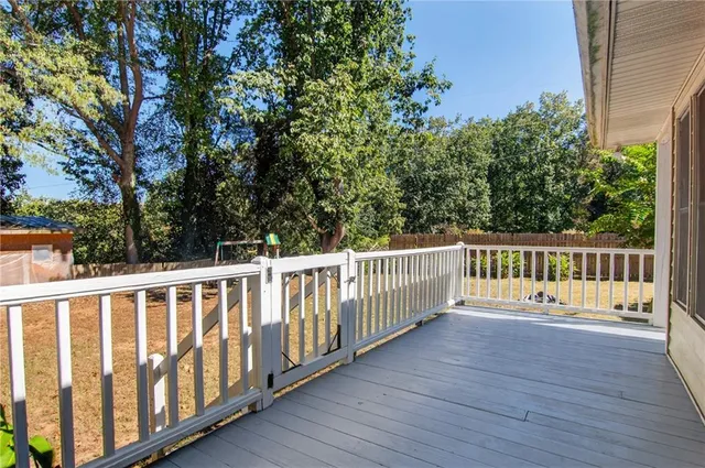 a balcony with wooden floor and fence