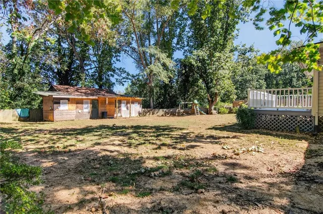 a backyard of a house with large trees