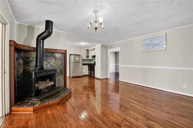 a view of a livingroom with fireplace wooden floor and a fireplace