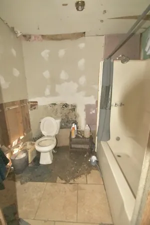 a bathroom with a toilet and a shower