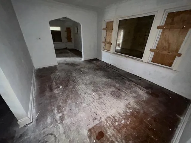 a view of empty room with window and fireplace