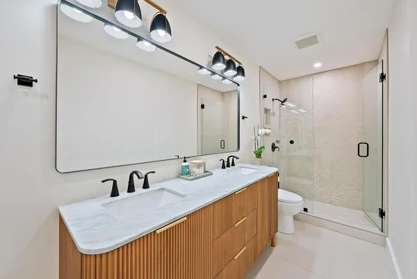 a bedroom with a bed and a wall painting