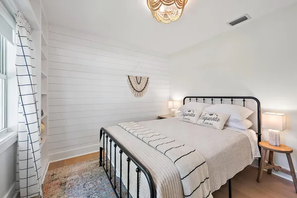 a bedroom with a bed and a window