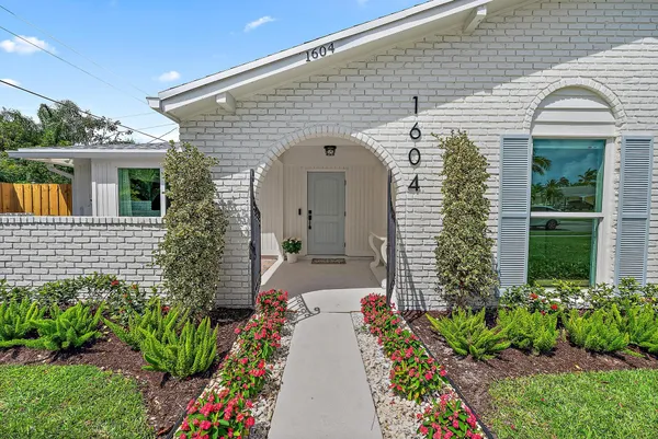 a front view of a house with a garden