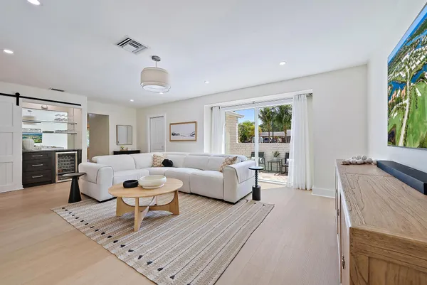 a living room with furniture a rug and a flat screen tv