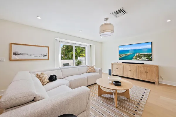 a bedroom with furniture and a flat screen tv
