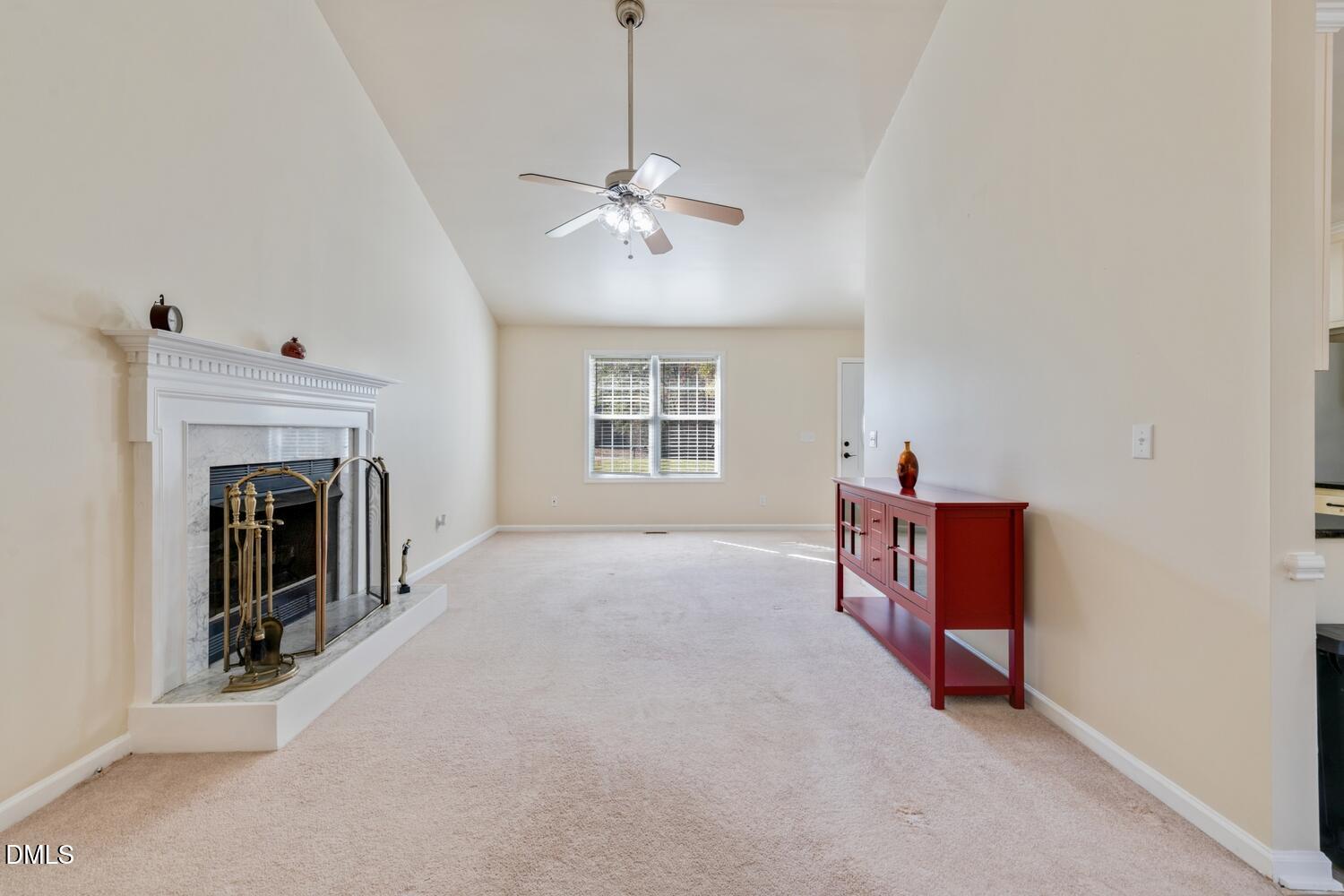 136 Pebblestone Court Willow Spring, NC 27592 - Photo 12 of 24 a view of livingroom with furniture fireplace and fan