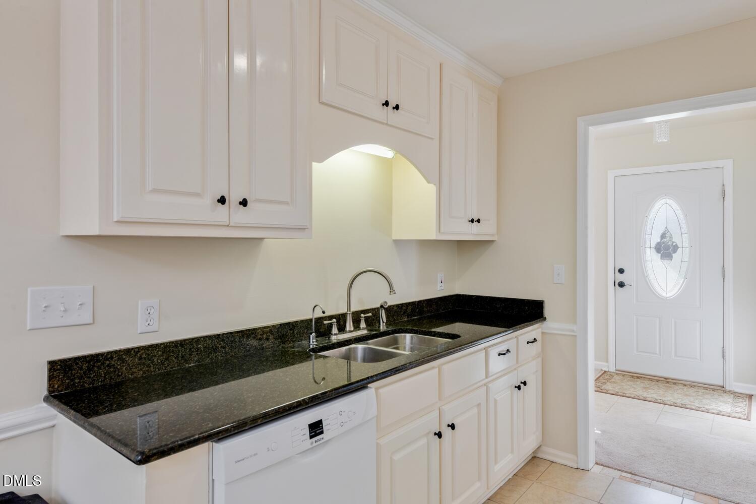 136 Pebblestone Court Willow Spring, NC 27592 - Photo 14 of 24 a kitchen with granite countertop white cabinets and sink