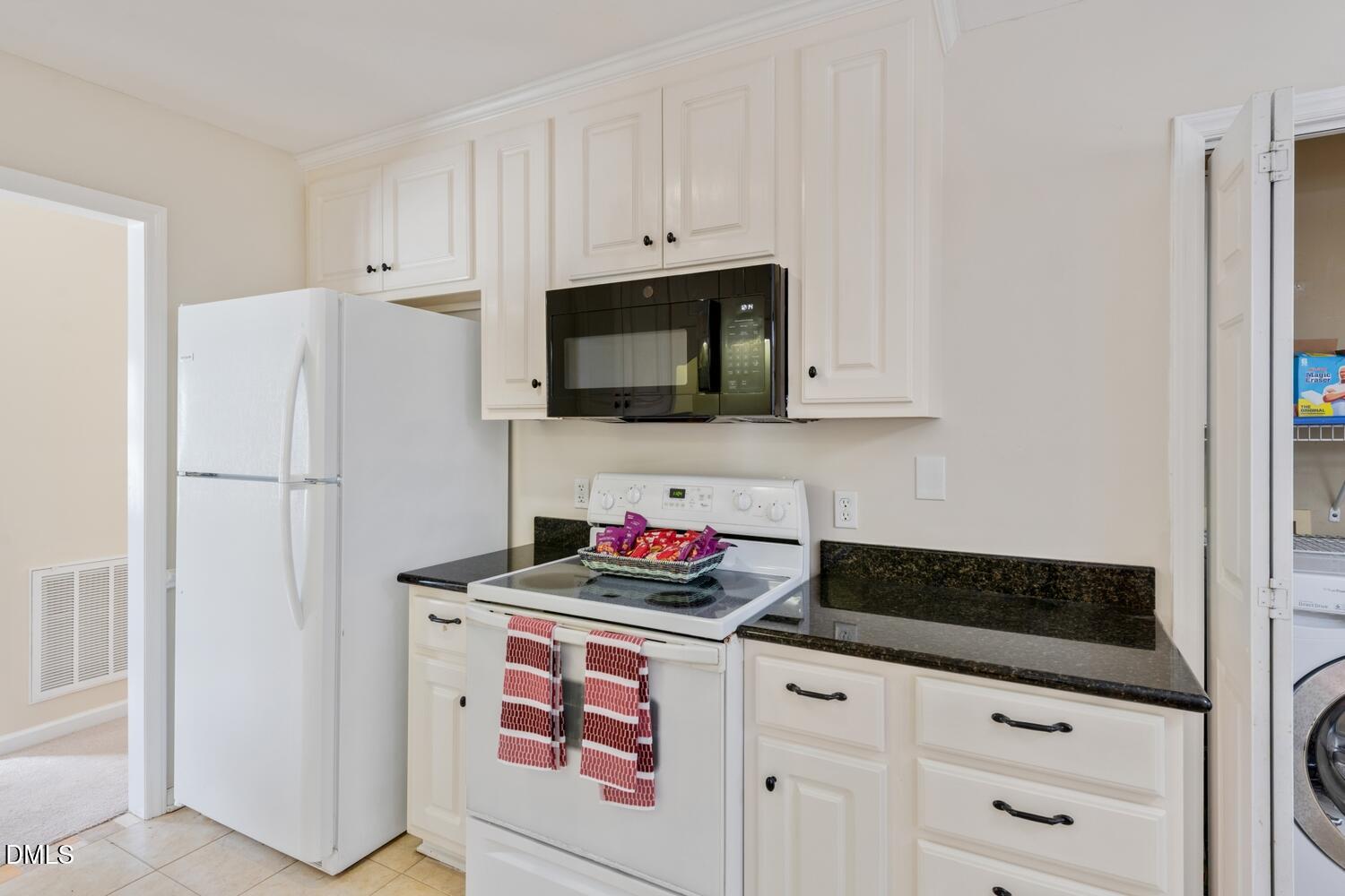 136 Pebblestone Court Willow Spring, NC 27592 - Photo 16 of 24 a kitchen with stainless steel appliances white cabinets and a stove