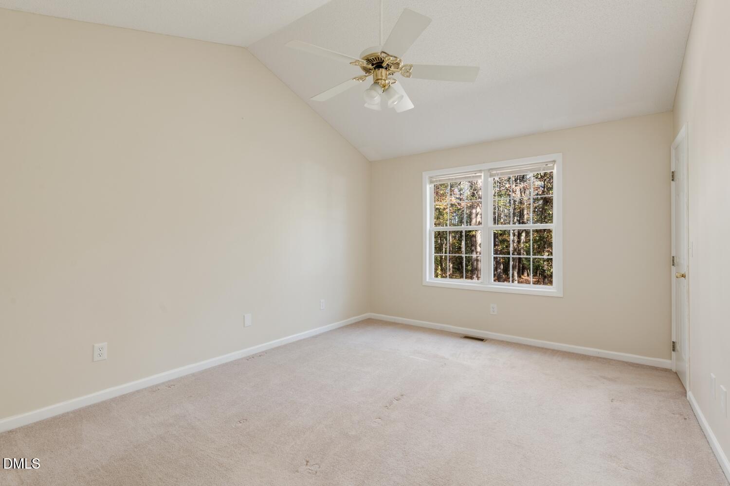 136 Pebblestone Court Willow Spring, NC 27592 - Photo 21 of 24 an empty room with a window and a ceiling fan