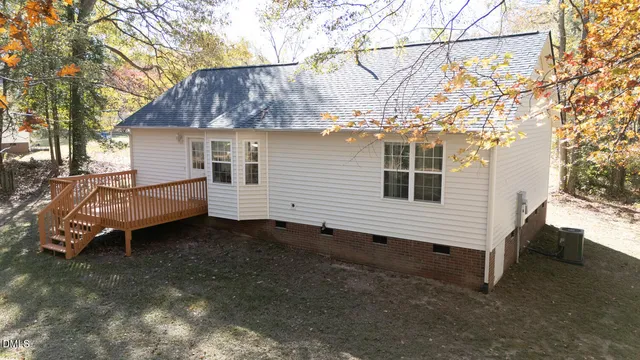 a view of a house with a yard and sitting area