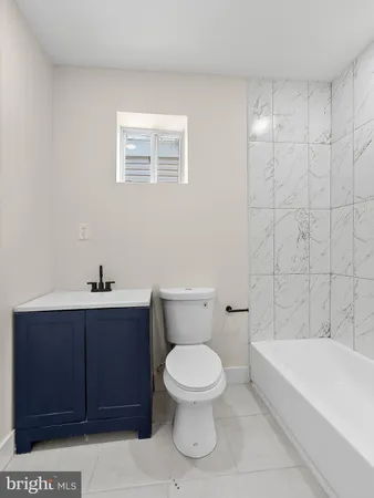 a bathroom with a toilet a sink and bathtub
