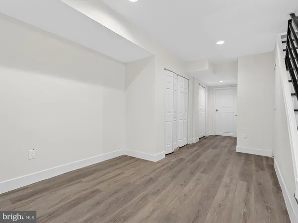 a view of wooden floor and an entryway in a room