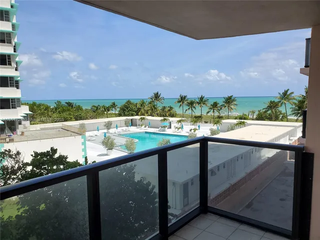 a view of swimming pool from a balcony