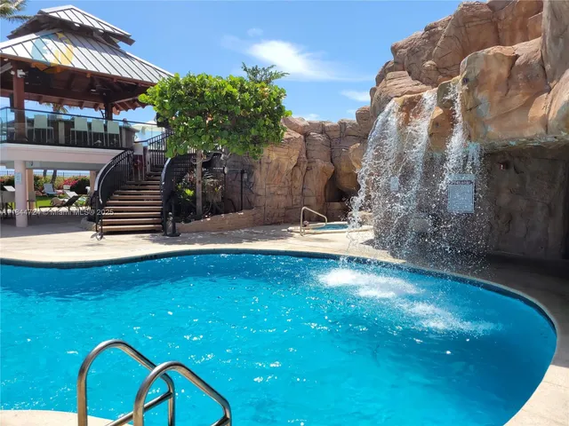 a view of a swimming pool with a patio