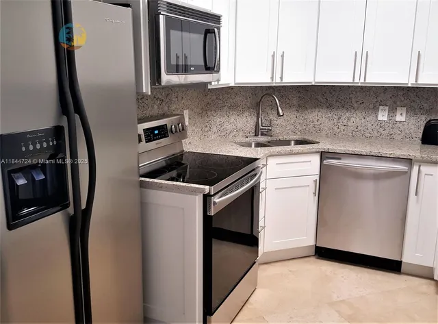 a kitchen with a sink stove and refrigerator