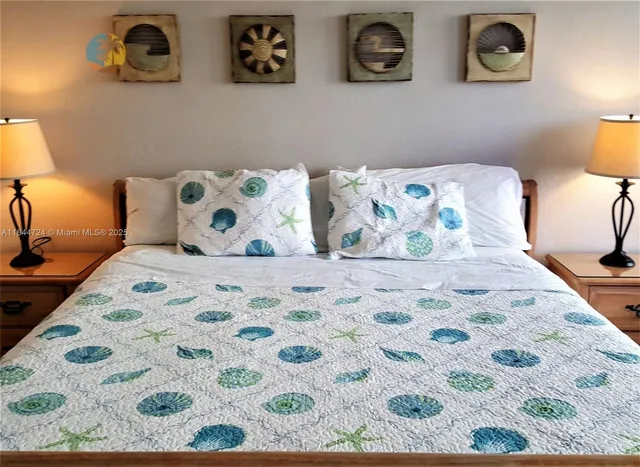 a large bed with painting on the wall