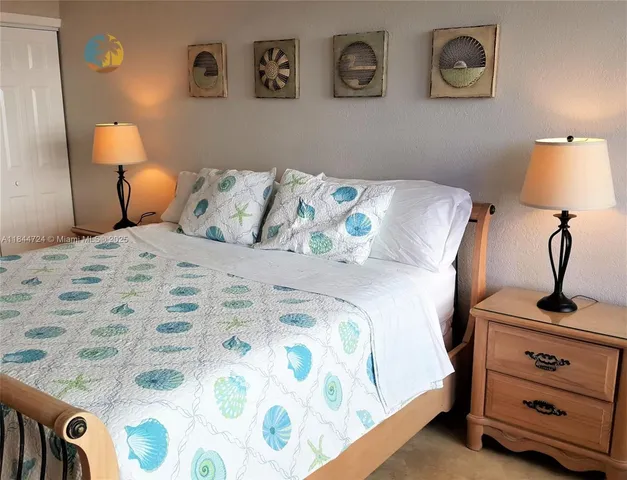 a bedroom with a bed and lamp