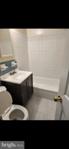 a view of kitchen with granite countertop stainless steel appliances
