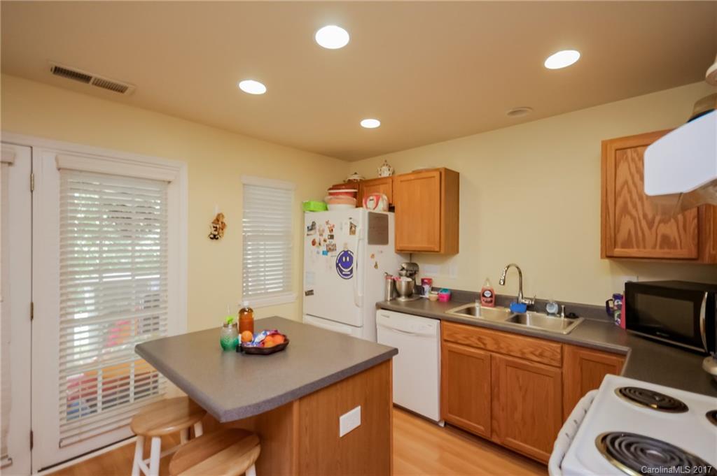 150 Limerick Road, Unit C Mooresville, NC 28115 - Photo 11 of 17 a kitchen with stainless steel appliances a sink a stove a table and chairs