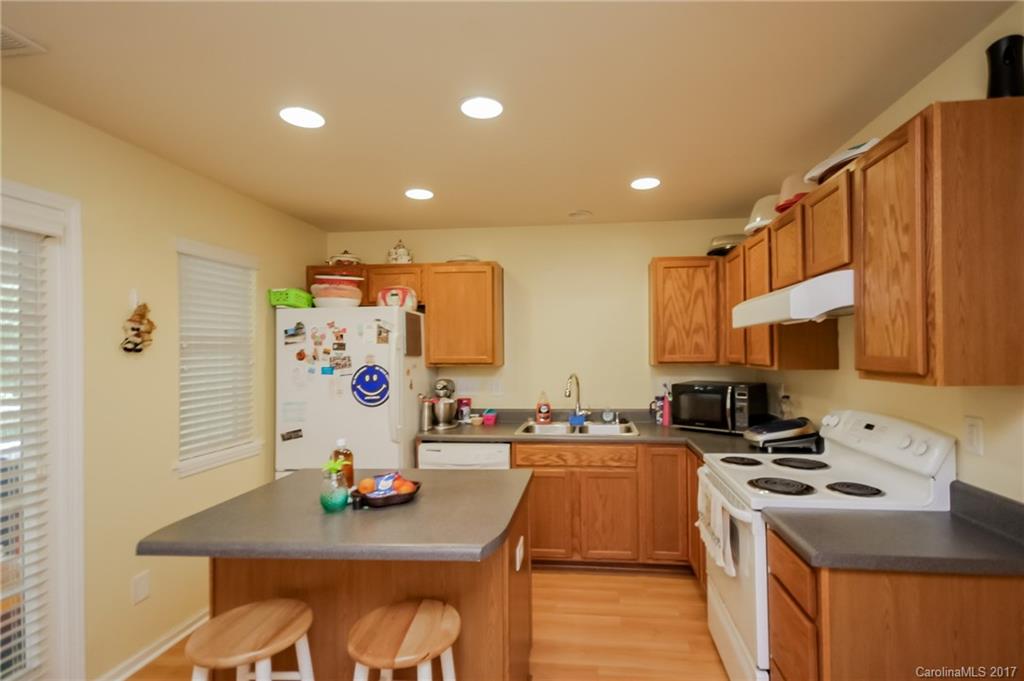 150 Limerick Road, Unit C Mooresville, NC 28115 - Photo 12 of 17 a kitchen that has a lot of cabinets a sink and appliances in it