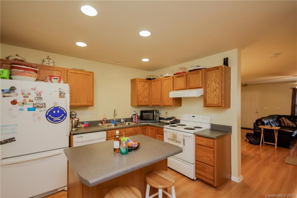 150 Limerick Road, Unit C Mooresville, NC 28115 - Photo 13 of 17 a kitchen with granite countertop a sink appliances and cabinets