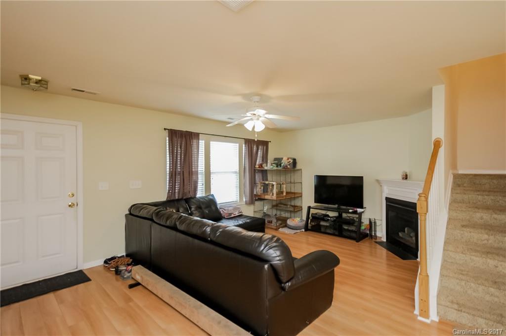 150 Limerick Road, Unit C Mooresville, NC 28115 - Photo 6 of 17 a living room with furniture a fireplace and a flat screen tv
