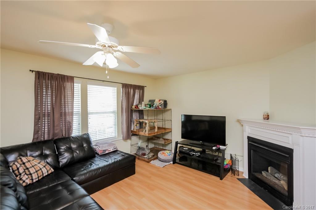 150 Limerick Road, Unit C Mooresville, NC 28115 - Photo 7 of 17 a living room with furniture a fireplace and a flat screen tv