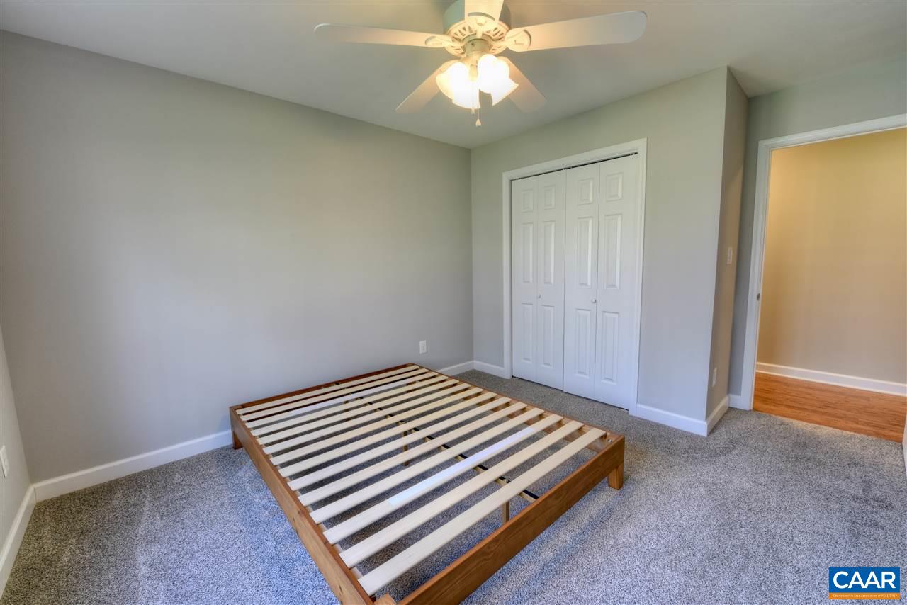 9 Buck Island Road Palmyra, VA 22963 - Photo 13 of 28 a bedroom with a bed and a chandelier fan