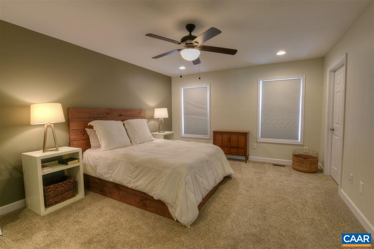 9 Buck Island Road Palmyra, VA 22963 - Photo 16 of 28 a spacious bedroom with a bed and a chandelier