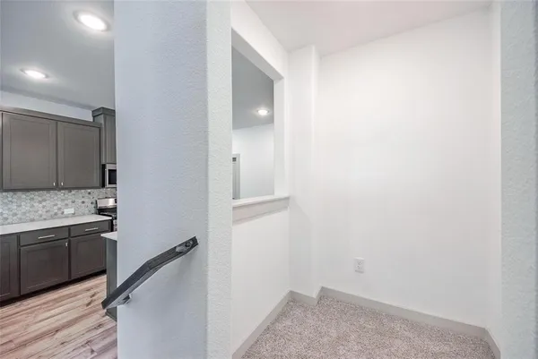 a view of a kitchen from the hallway