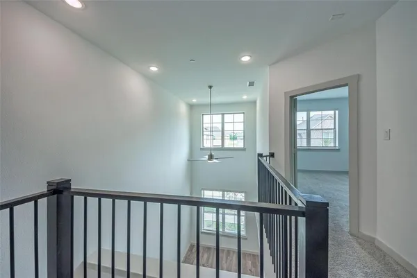 a view of a hallway with windows