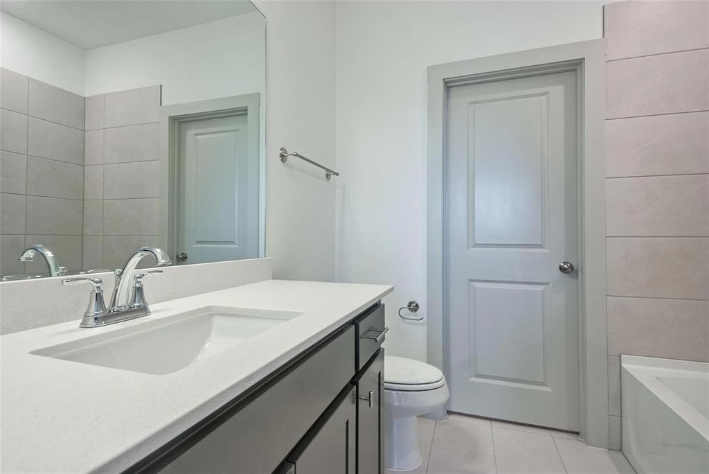 692 Vista Oak Road Lewisville, TX 75067 - Photo 20 of 39 a bathroom with a sink a toilet and shower