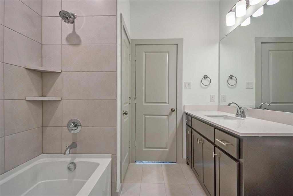 692 Vista Oak Road Lewisville, TX 75067 - Photo 21 of 39 a bathroom with a tub sink vanity granite and shower