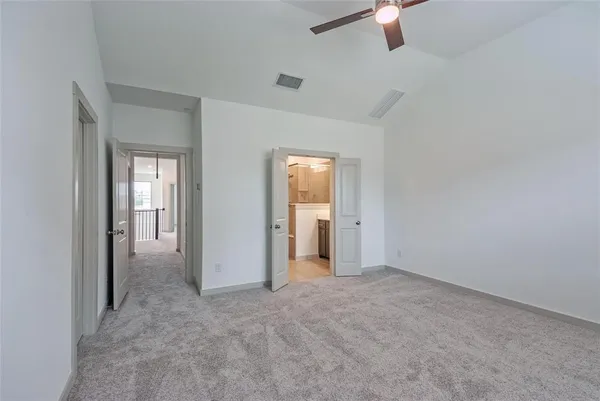 a view of an empty room with a ceiling fan