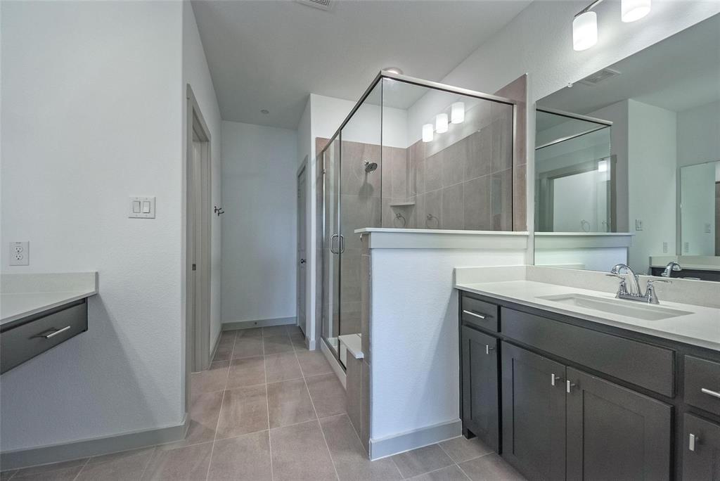 692 Vista Oak Road Lewisville, TX 75067 - Photo 29 of 39 a bathroom with a sink and mirror