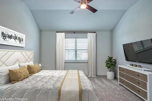 a bedroom with a bed and a television