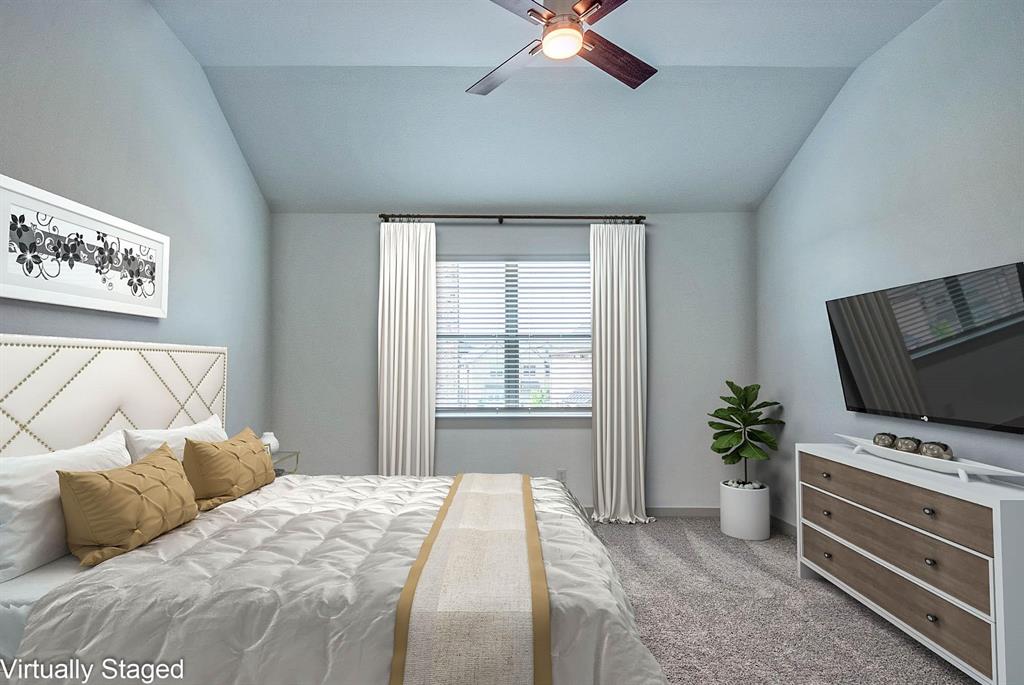 692 Vista Oak Road Lewisville, TX 75067 - Photo 3 of 39 a bedroom with a bed and a television