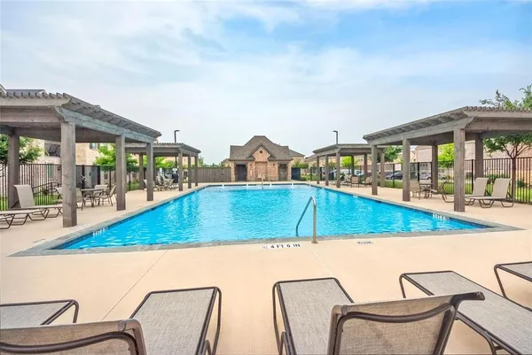 a view of swimming pool with chairs