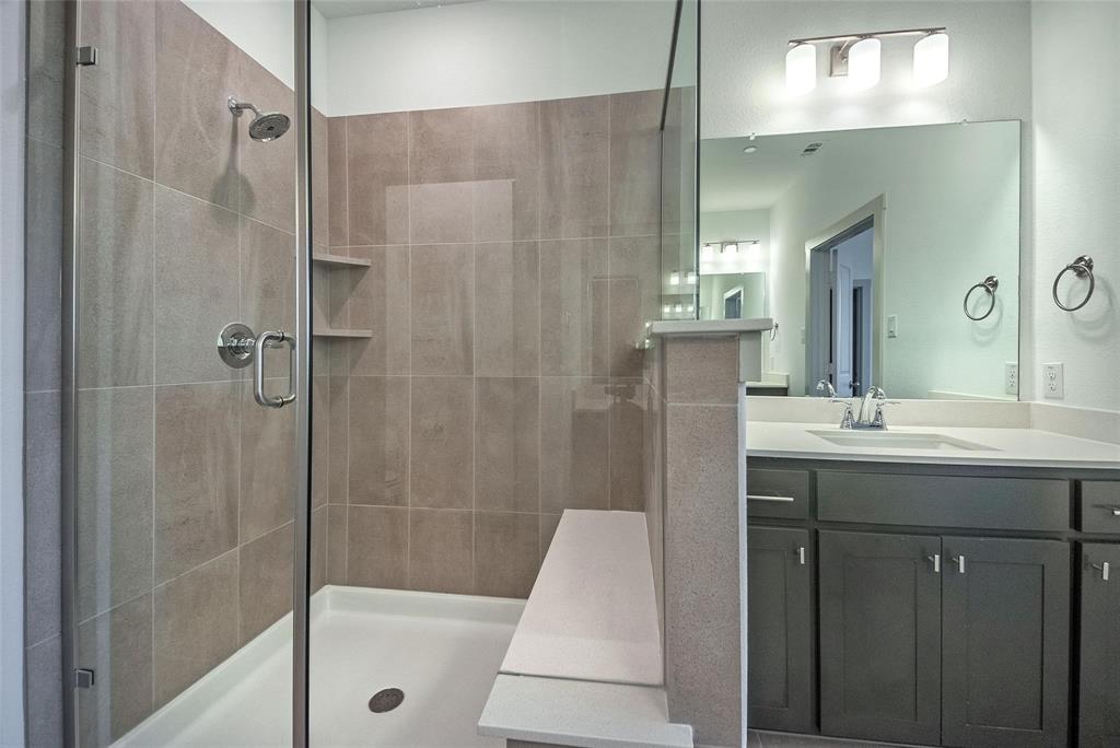 692 Vista Oak Road Lewisville, TX 75067 - Photo 7 of 39 a bathroom with a sink a toilet a mirror and shower