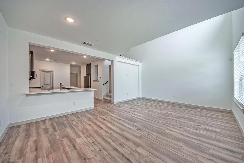692 Vista Oak Road Lewisville, TX 75067 - Photo 8 of 39 a view of a big room with wooden floor and windows