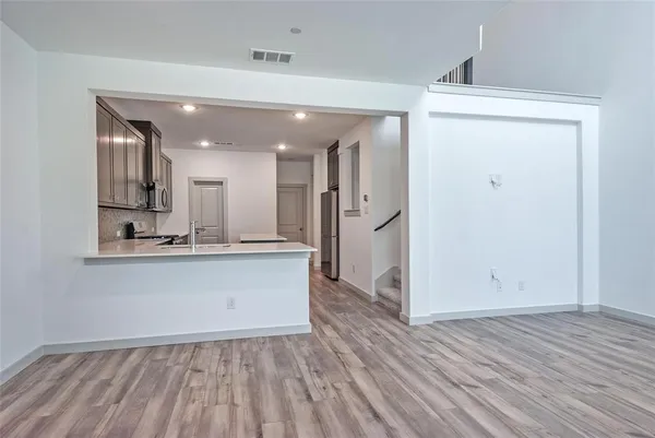 a view of kitchen with sink and wooden floor