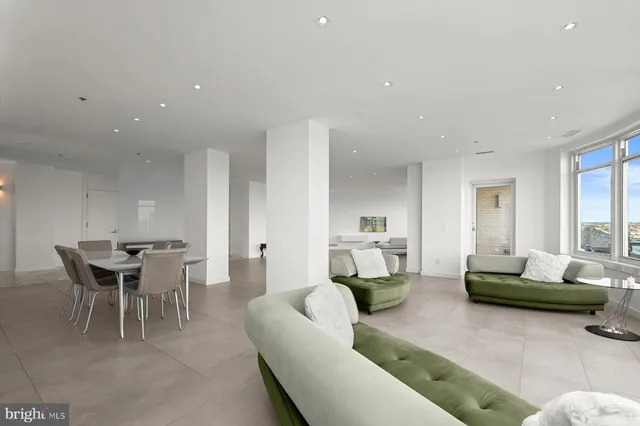 a large white kitchen with a large window