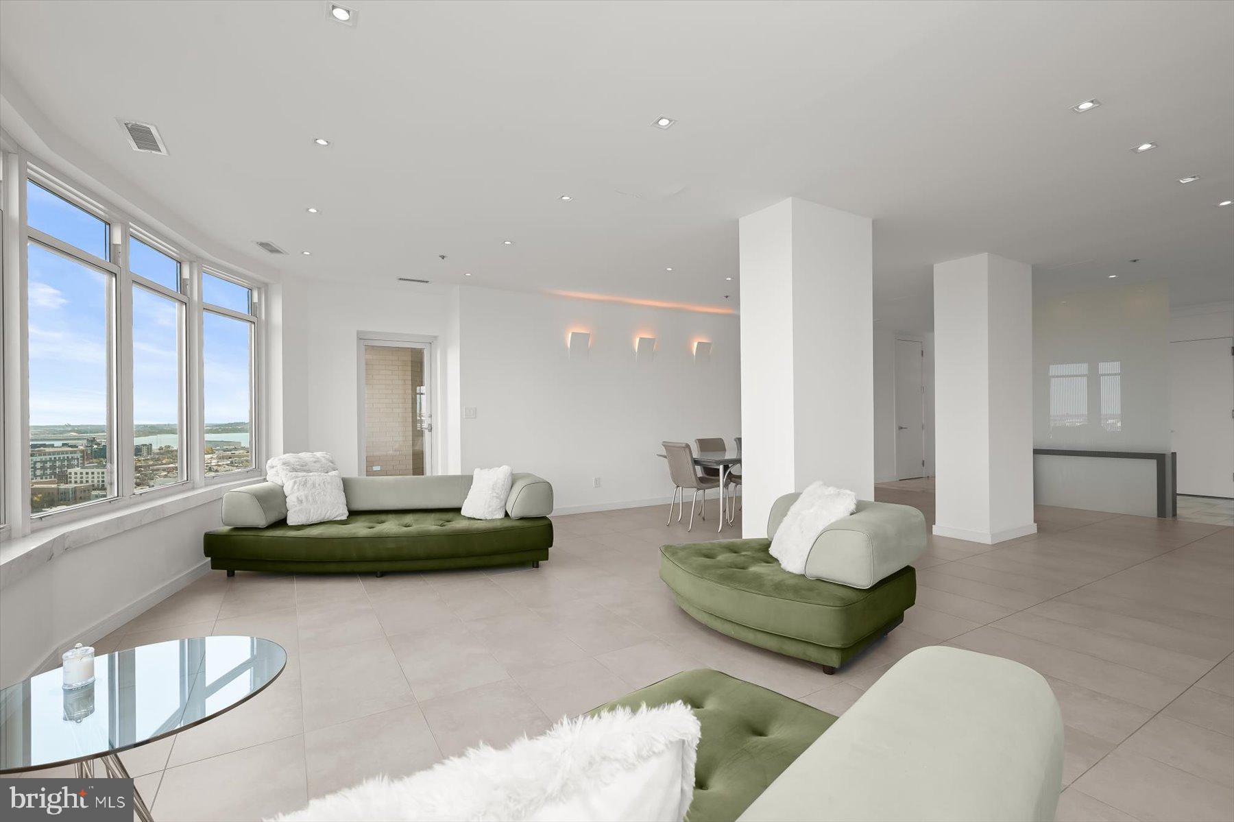 100 Harborview Drive, Unit 1901 Baltimore, MD 21230 - Photo 15 of 107 a living room with furniture and a large window