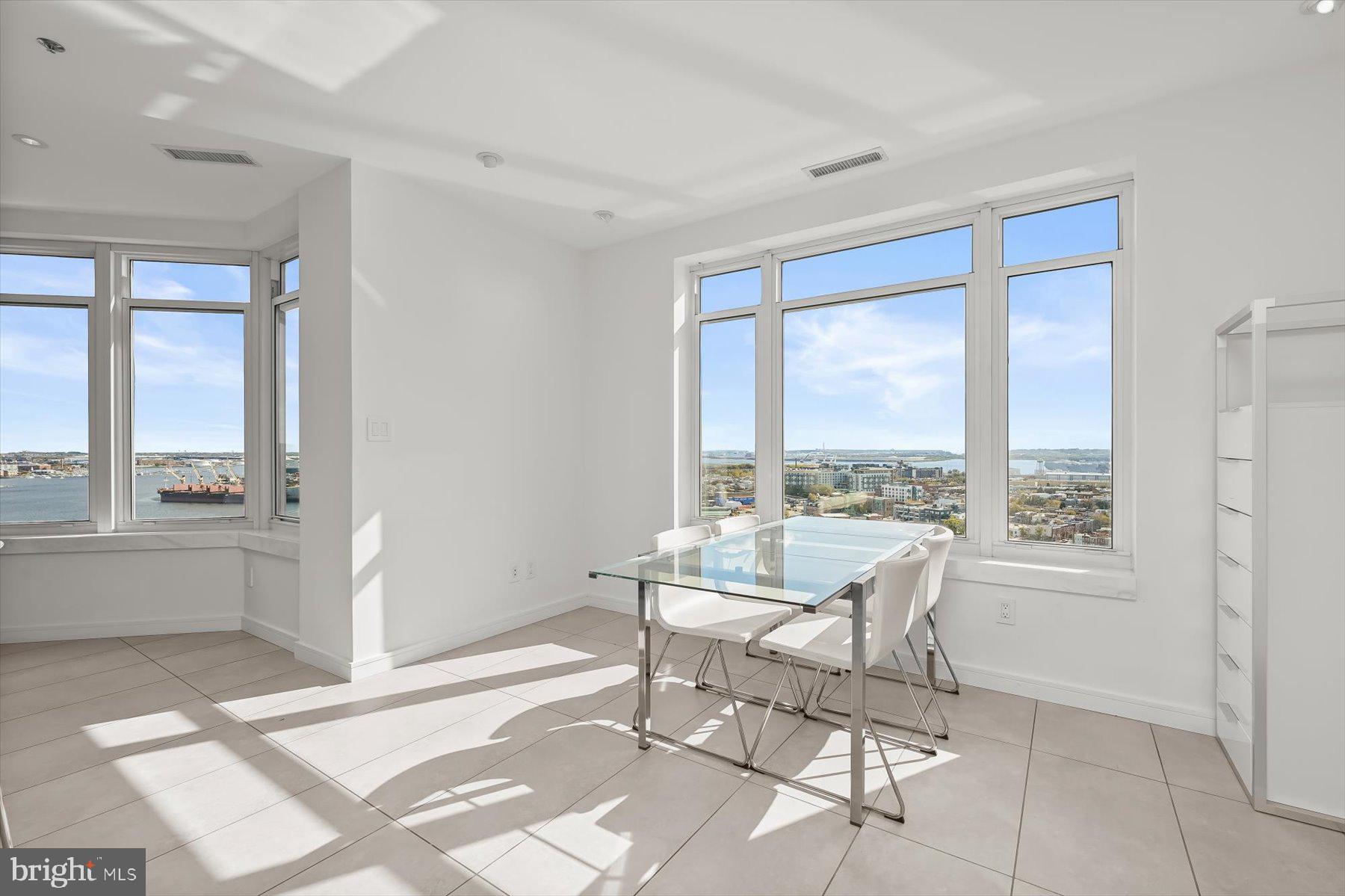 100 Harborview Drive, Unit 1901 Baltimore, MD 21230 - Photo 27 of 107 a living room with a large window and a table