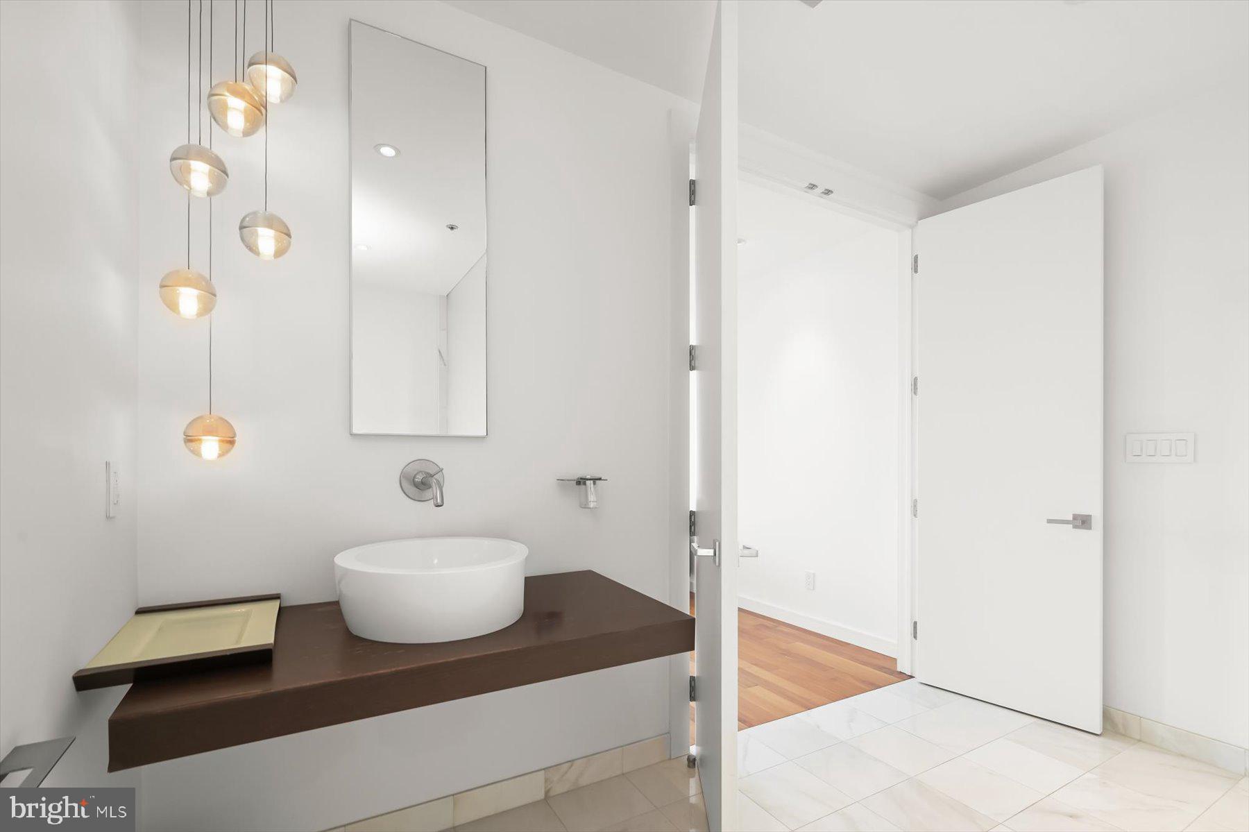 100 Harborview Drive, Unit 1901 Baltimore, MD 21230 - Photo 34 of 107 a bathroom with a sink and a mirror