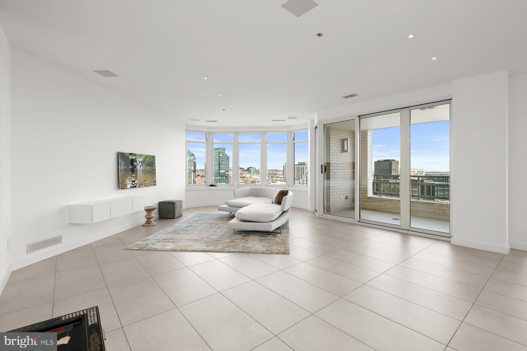 100 Harborview Drive, Unit 1901 Baltimore, MD 21230 - Photo 5 of 107 a living room with furniture and a floor to ceiling window